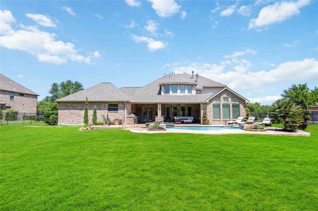 Enormous backyard featuring a patio, replastered pool, and spa.