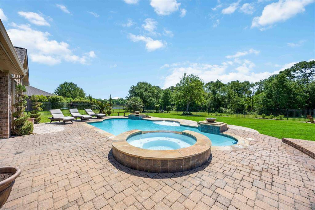 Backyard featuring a spa, pool, and complete privacy with no neighbors behind.