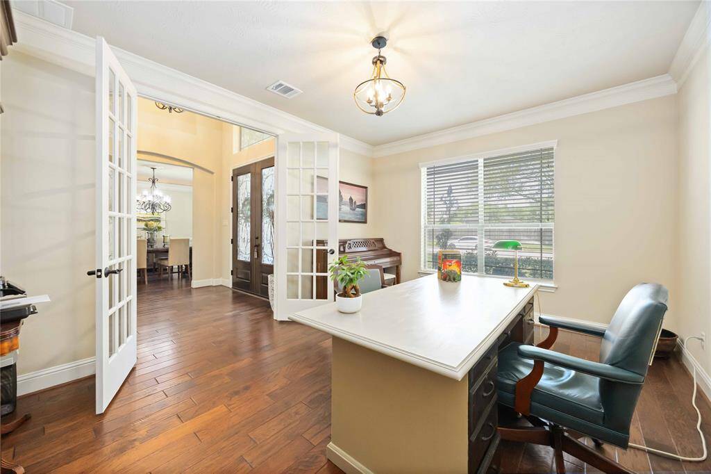 As you enter the study/office you're greeted by an inviting atmosphere. The natural light filters in through the elegant French doors.
