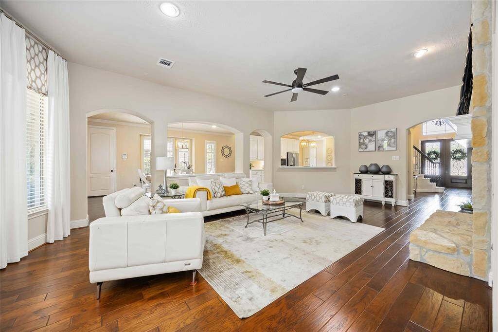 A family room that offers a seamless view of the kitchen, breakfast area, and front entrance.
