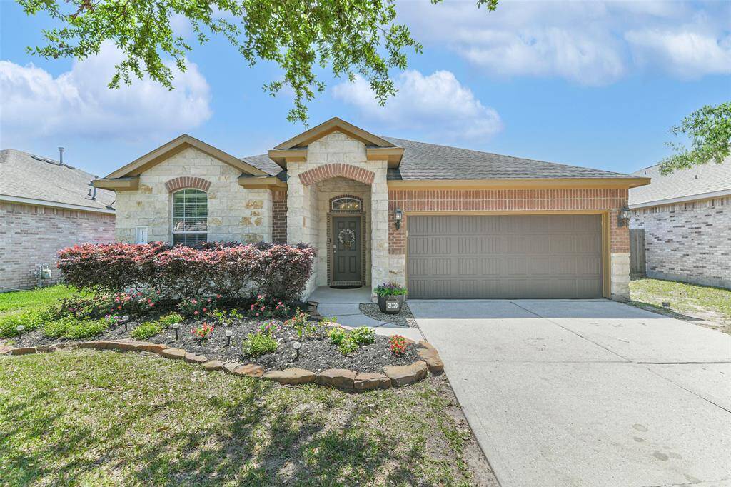 Charming curb appeal with lush landscaping and inviting entry!