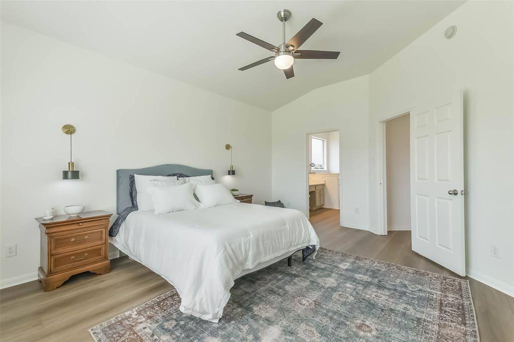 Luxurious primary bedroom featuring elegant custom lighting.