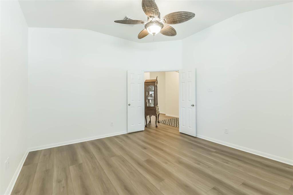 Spacious flex room with elegant double doors, perfect for a home office or creative space.