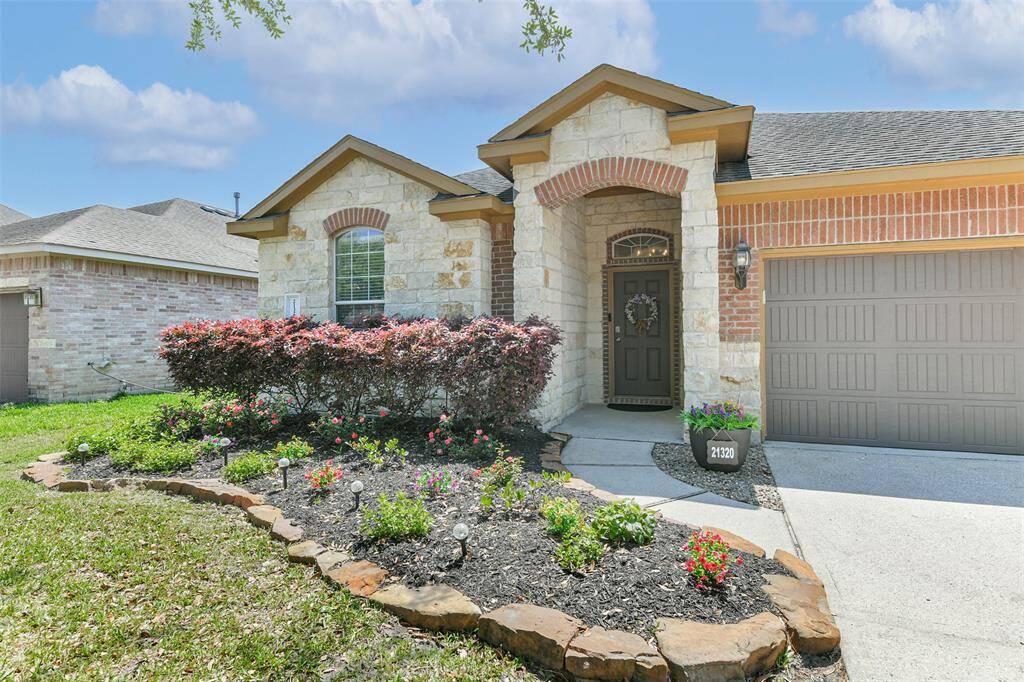 A welcoming path leads to the charming covered front porch.