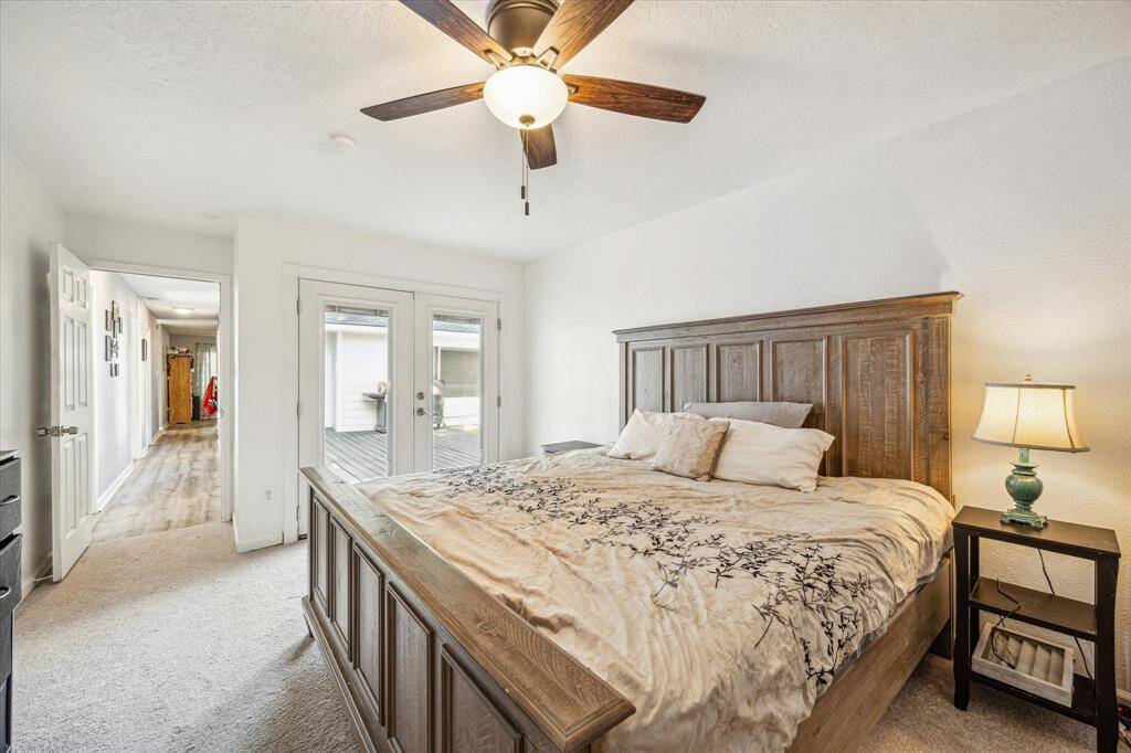 Primary bedroom overlooks deck