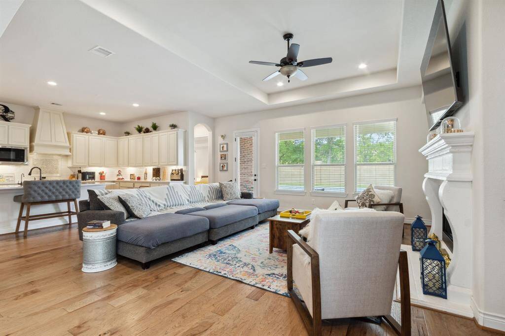 The living room comes with a stone-cast fireplace and beautiful views of the backyard.  Note how functional and flexible this open space can be for entertaining or the daily routine.