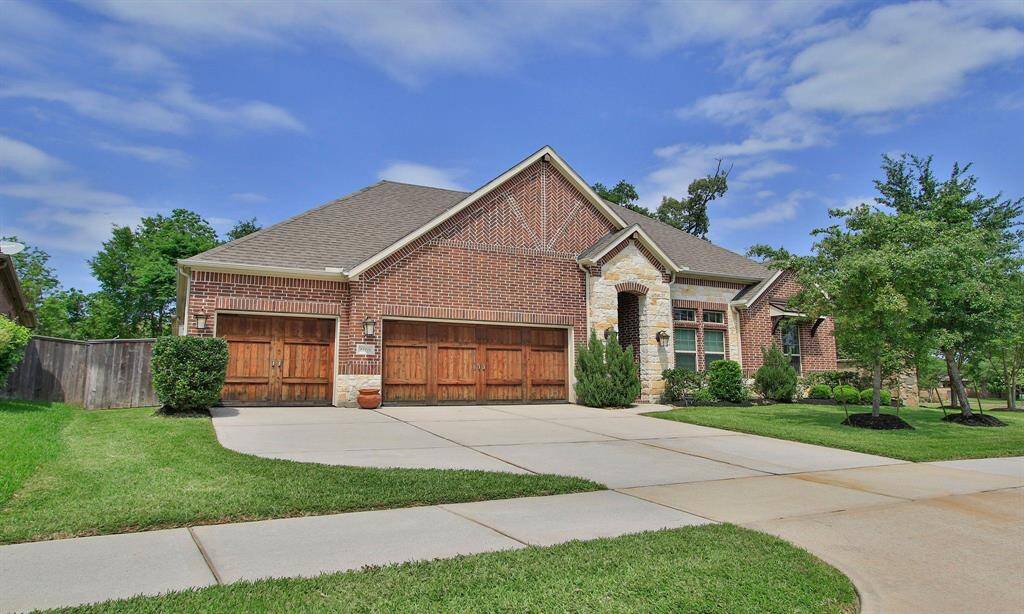 Beautiful brick and stone elevation with a 3-car garage and double-wide driveway.