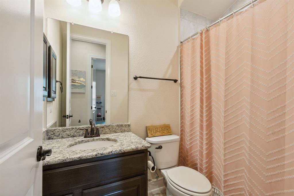 Guest bath with tub/shower combo.
