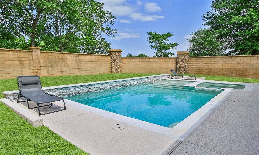 Meticulously maintained swimming pool and spa with marble coping and Pebbletec surface.