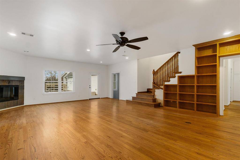 Grand living room with cozy fireplace, built in shelving. Wooden staircase leads to the second story, 2 additional bedrooms, bathroom and walk out attic.