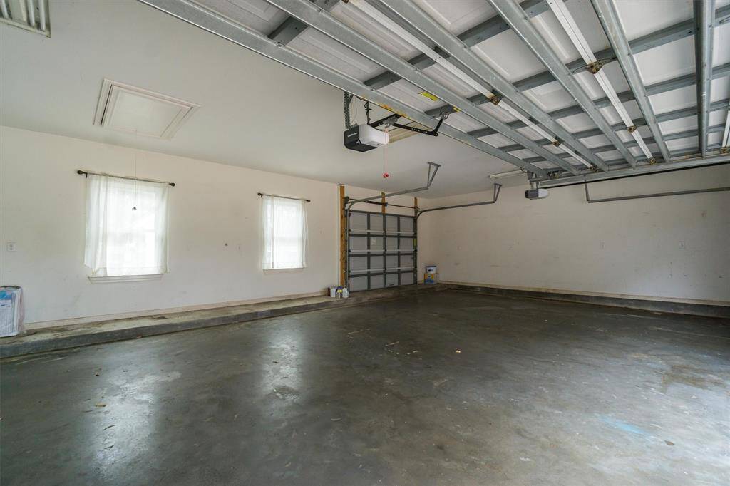 3 car garage, windows overlook the pool and the 3rd bay with drive through back yard/back patio/pool!