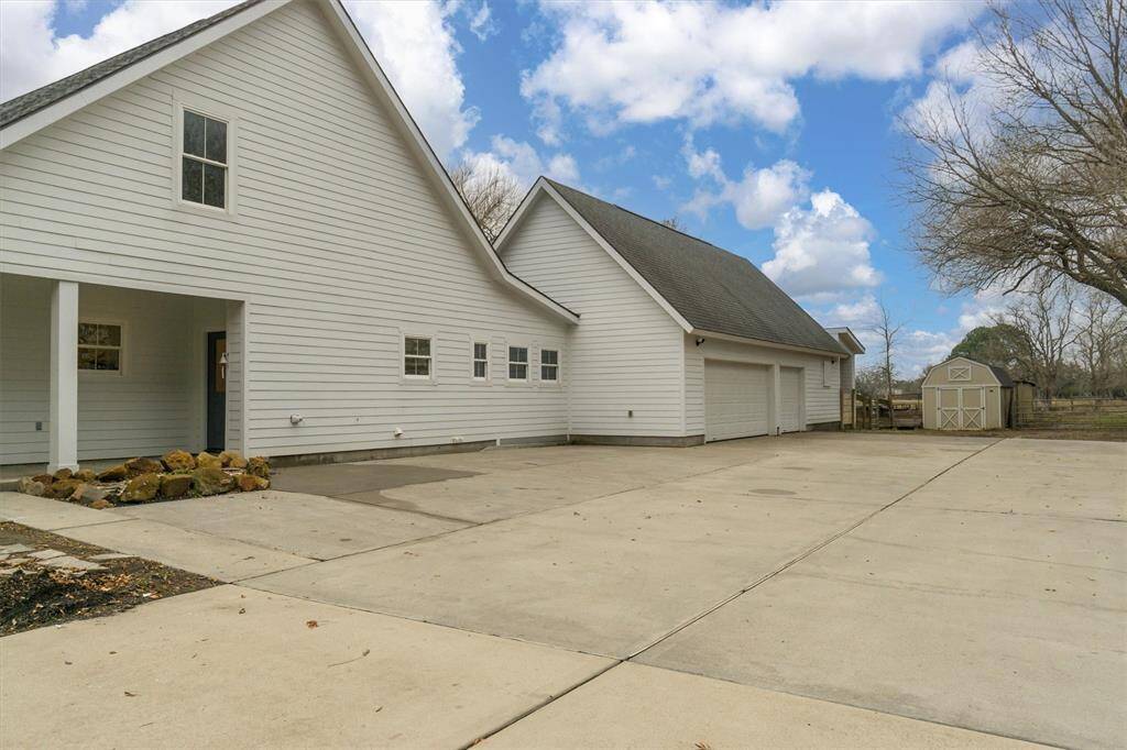Plenty of driveway space leading to the three car garage, Horse stalls and back pasture.