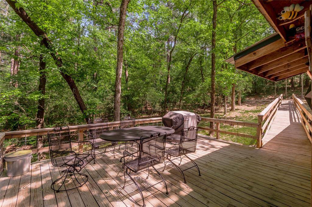 Larger side of the deck. Patio furniture and grill will remain with the home at price listed.  There are cushions in storage under home.