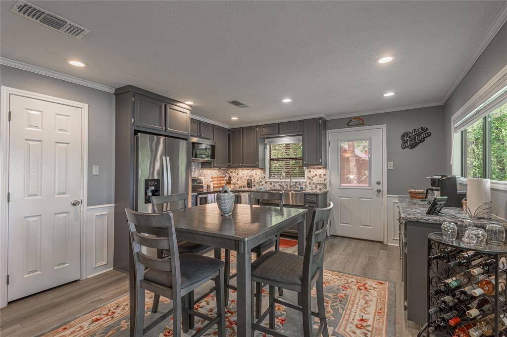 Dine in kitchen is open to the living room. New Whirlpool matching appliances, quartz counter tops, delta faucets, farmhouse sink.