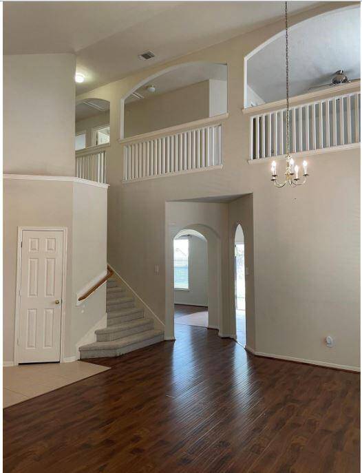 Front living area with formal dining space is a great place for entertaining. The storage closet by the stairs is a great place to tuck away the clutter.