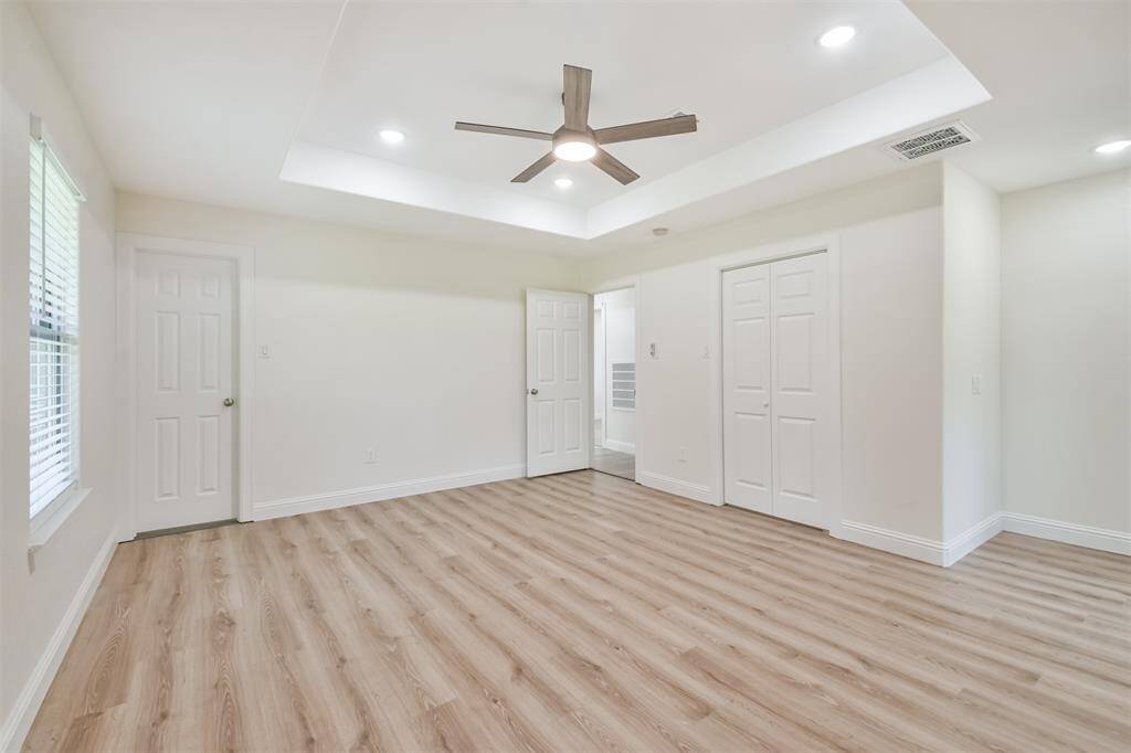 New wood look flooring and remote ceiling fan.