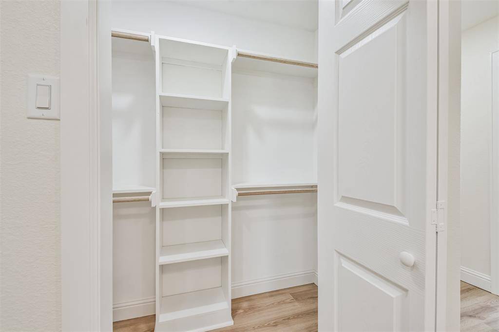 Second walk in closet in the Primary Bedroom with built in shelves.
