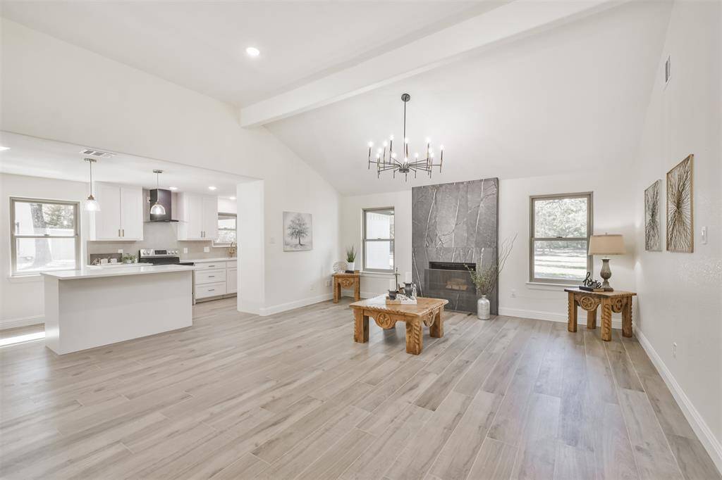 Every room and every detail was covered with new flooring, light fixtures, paint, plumbing, electrical, windows and roof and look at this stunning floor to ceiling stone wall surrounding the fireplace!