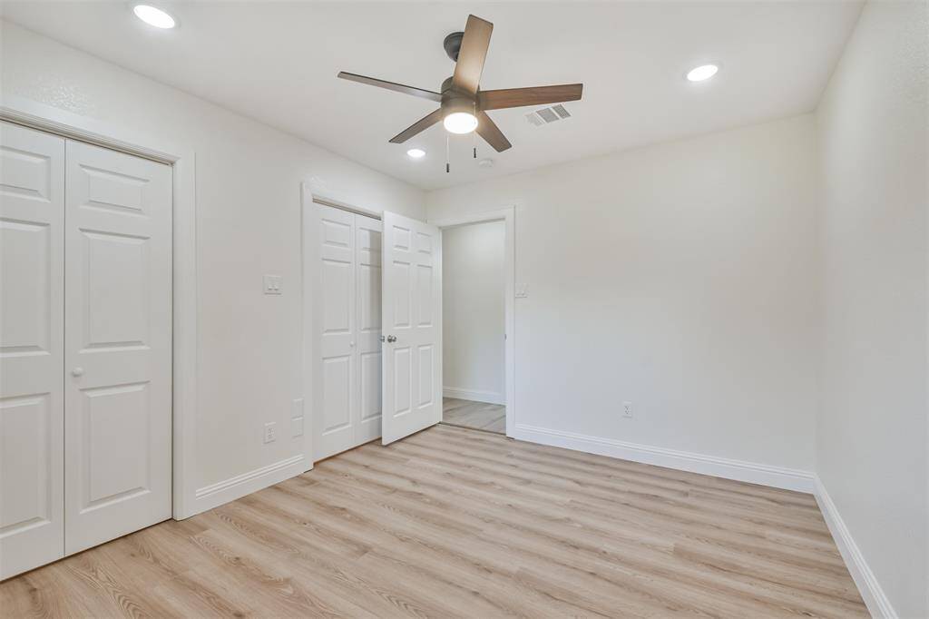 Third bedroom also with new wood look flooring and remote ceiling fan light fixture.