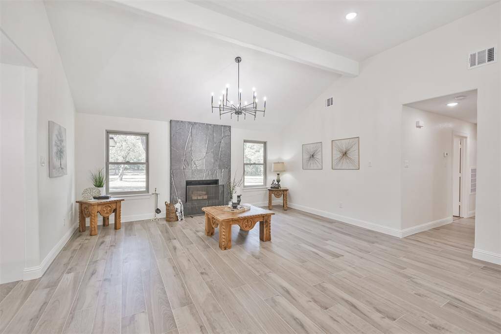 High 11 ft ceiling and large double paned windows with views to the acreage surrounding the home.