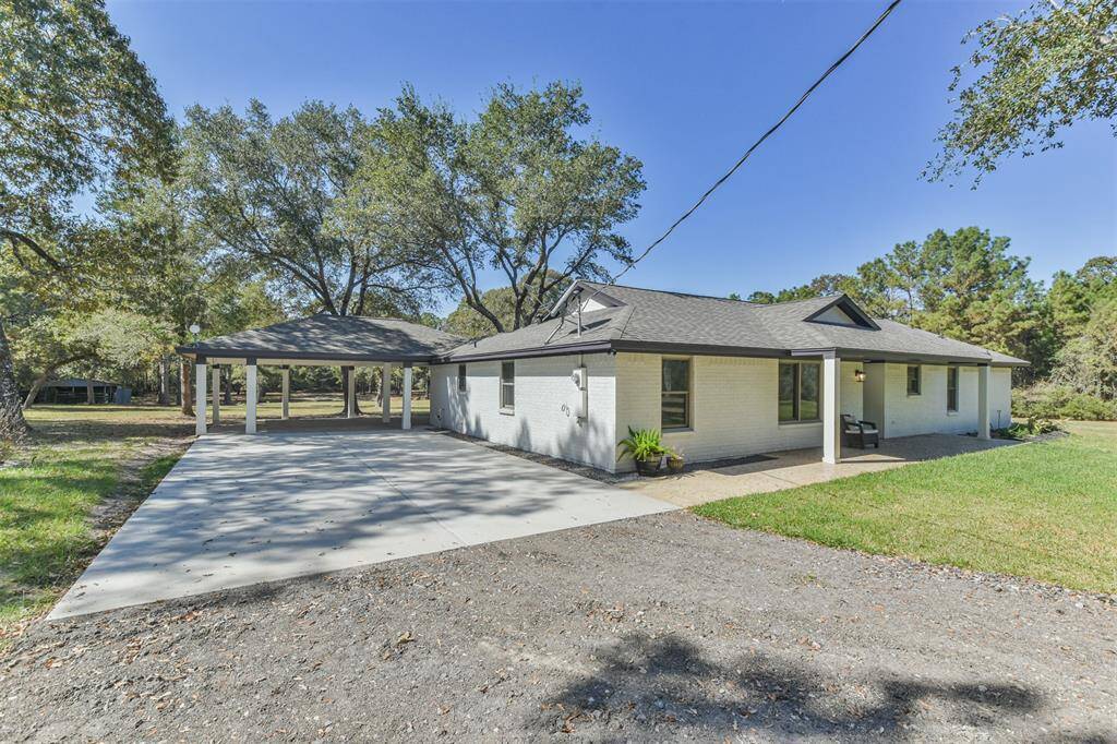All brick home with double wide driveway and carport.