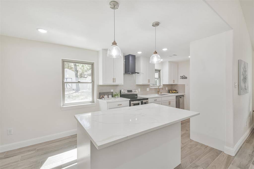 Center island with Quartz countertop adds a quaint space for breakfast.