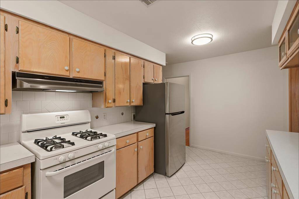 Kitchen with Gas Stove and New Refrigerator.