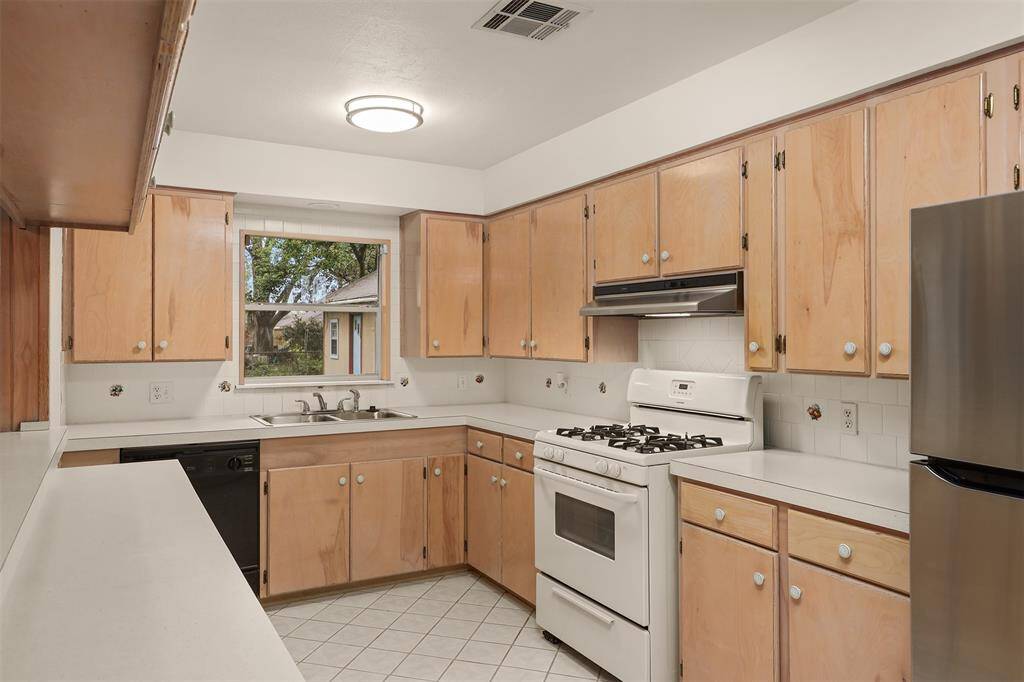 Kitchen with Gas Stove and New Refrigerator.