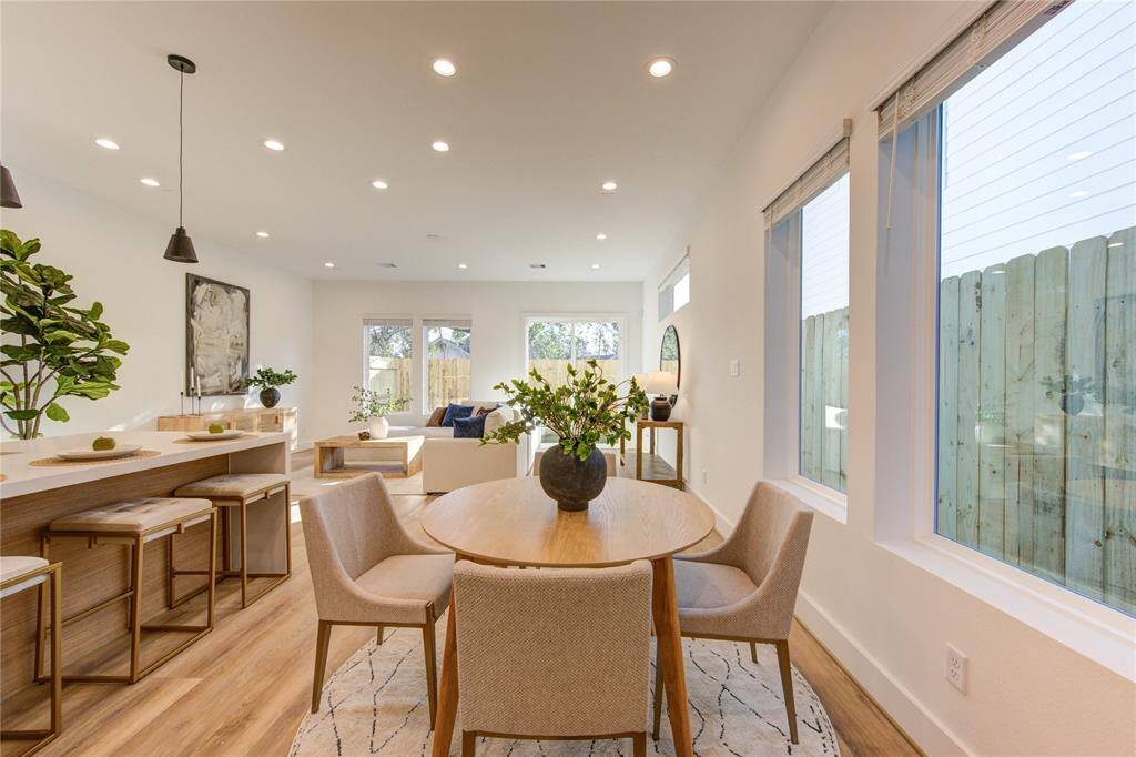 Dining room overlooks the kitchen with large windows for tons of natural lighting. Pre-wired for chandelier.