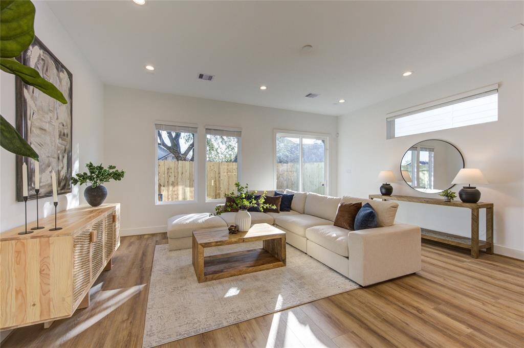 Large open living room with access to your private fenced in backyard.