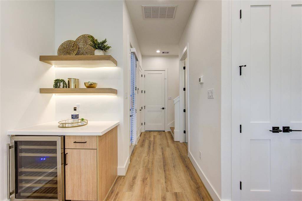 Dry bar with wine fridge adjacent to the dining area and pantry. This home is perfect for entertaining guests and family.