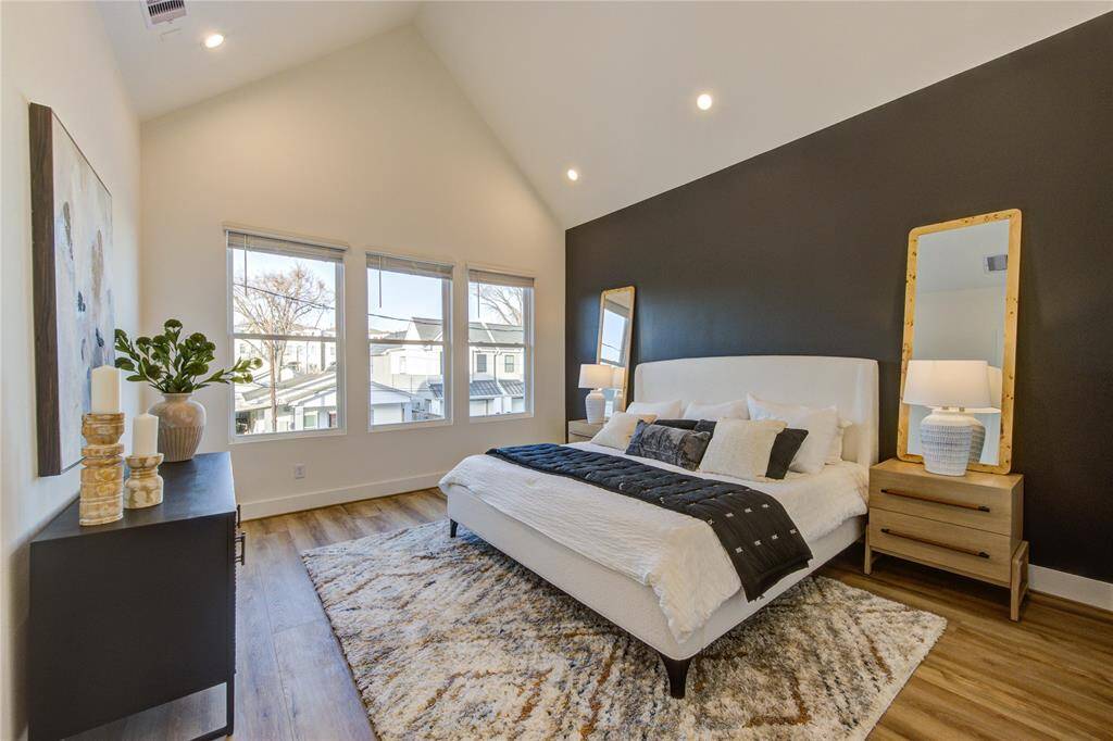 Primary bedroom with soaring cathedral ceilings and tons of natural light!