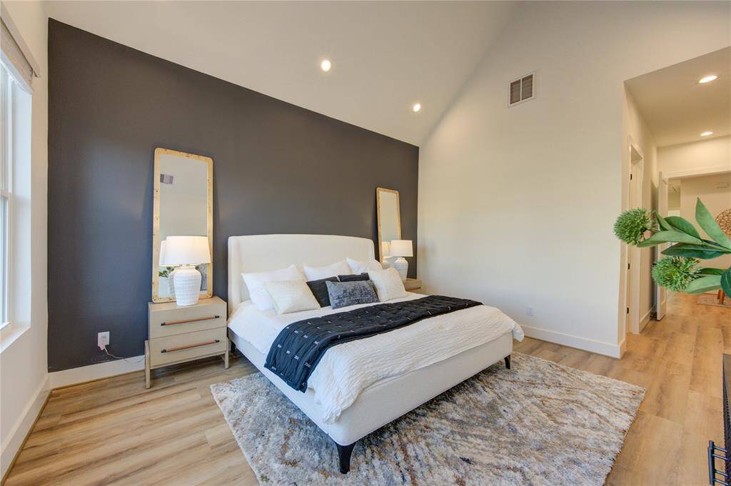 Primary bedroom with soaring cathedral ceilings and tons of natural light!