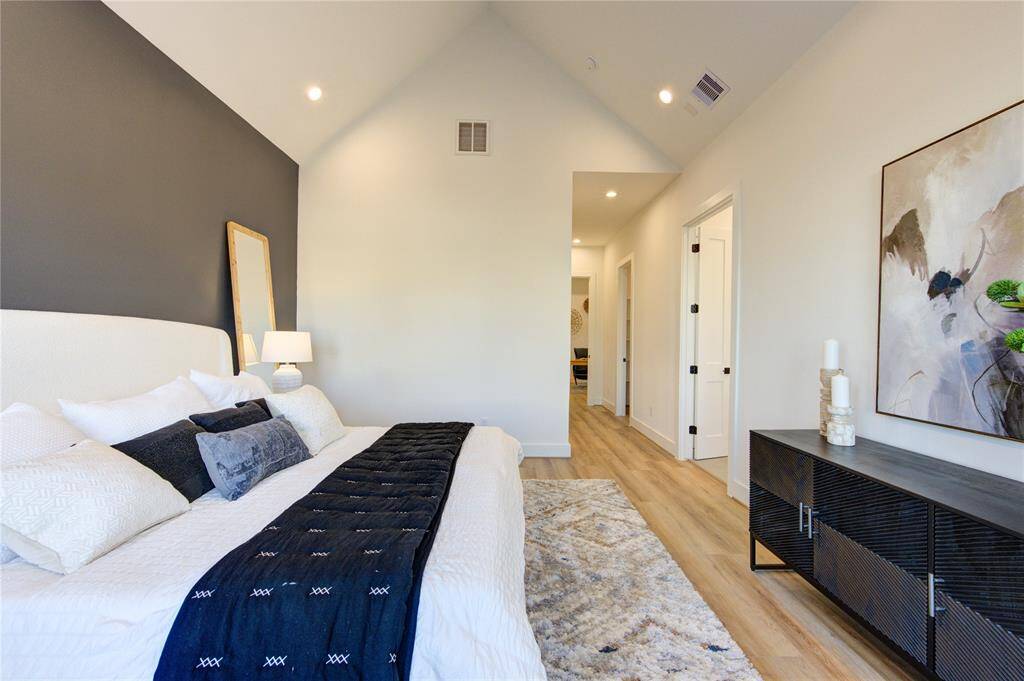 Primary bedroom with soaring cathedral ceilings and tons of natural light!