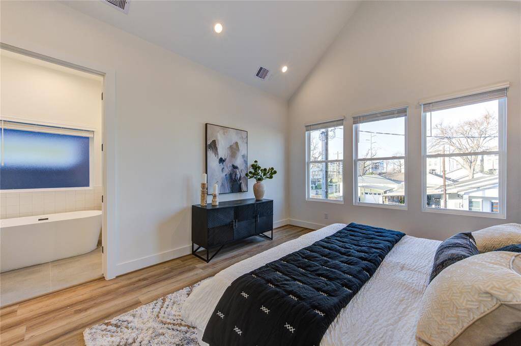 Primary bedroom with soaring cathedral ceilings and tons of natural light!