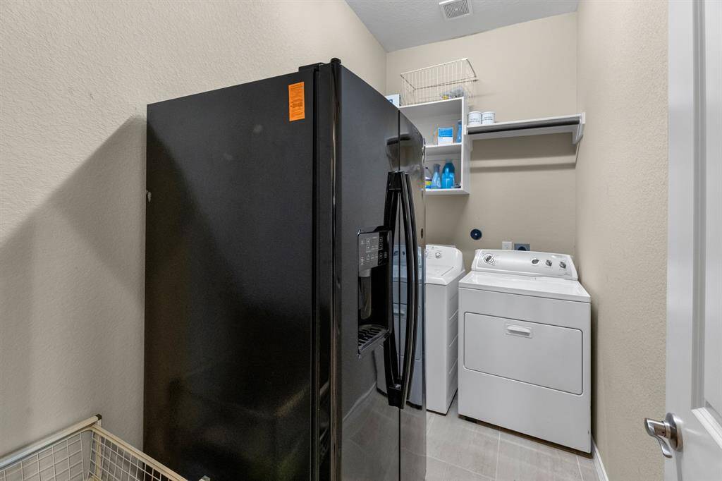 Nice having the utility room off the main hallway and with plenty of room for a second refrigerator or deep freezer.