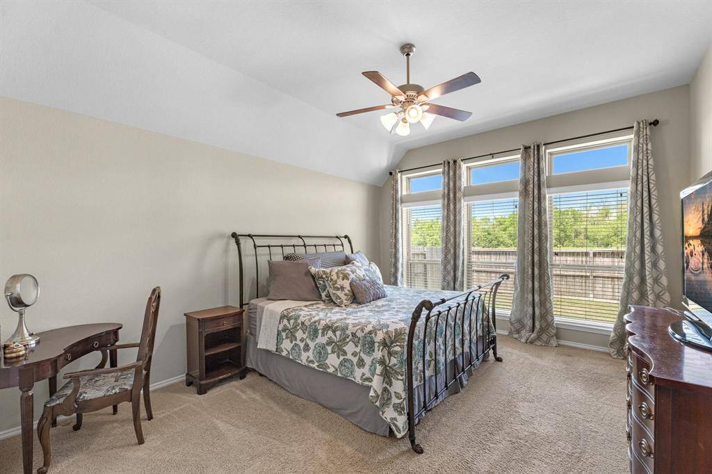 Primary bedroom with high ceilings.