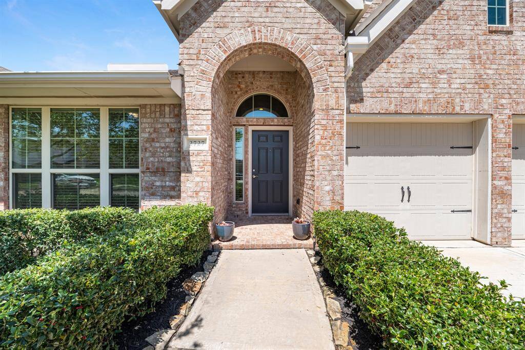 Inviting curb appeal with landscaped shrubs. All brick home.