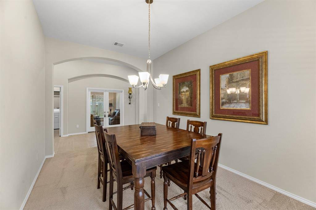 Another angle showing the formal dining room. Across the hallway to the left is a large utility room and glass French door study or game room.