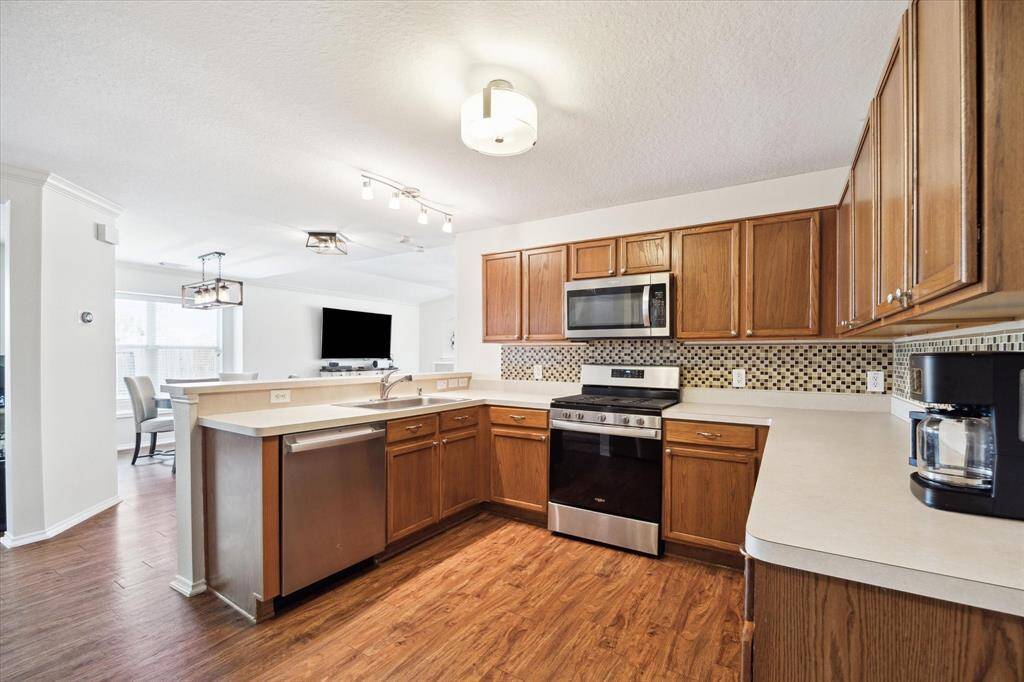 Kitchen is open to breakfast area. Beautiful light fixtures.