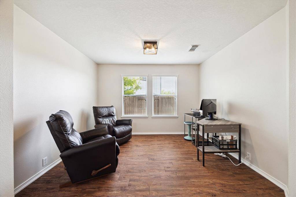 Second bedroom with ceiling fan and new carpeting.