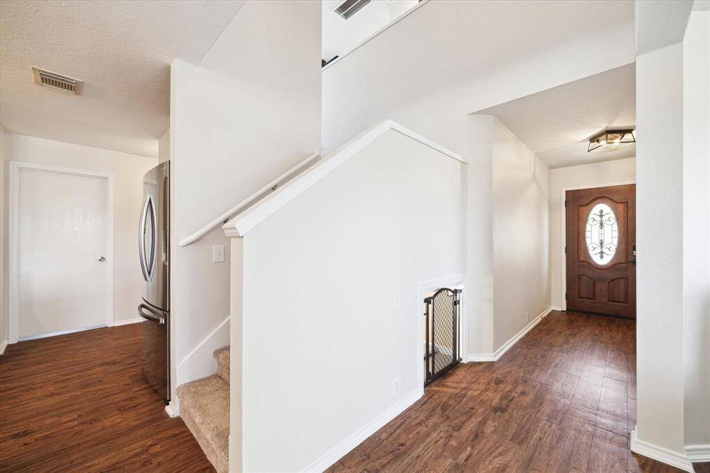 Solid wood and leaded glass front door at entry.