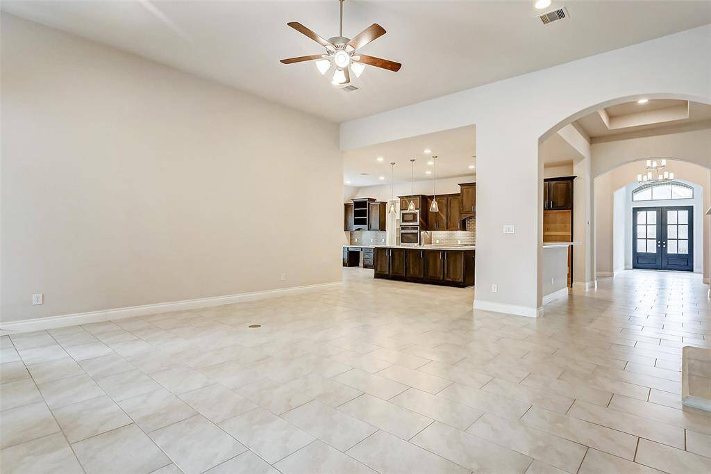 Abundant natural light pours in through large windows, brightening every corner of the room and creating a welcoming atmosphere throughout the home.