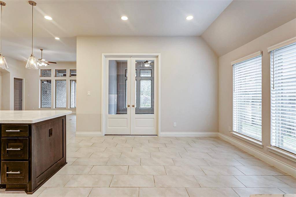 Elegant glass French doors open to reveal a spacious flex space, offering endless possibilities for use. Whether you need a quiet home office, a cozy reading nook, a playroom, or a versatile lounge area, this room can easily adapt to your lifestyle and needs.