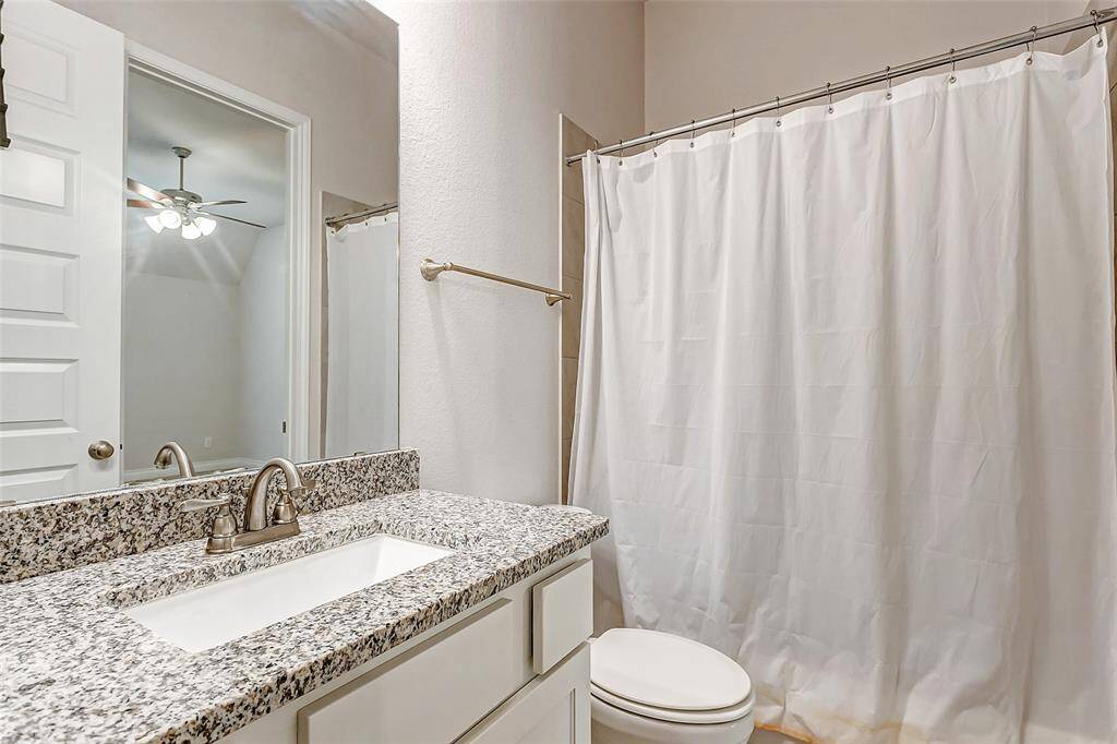 This private ensuite bathroom is designed with elegance and functionality in mind. It features a stunning granite countertop, a tub and shower combo, & a spacious walk-in closet.