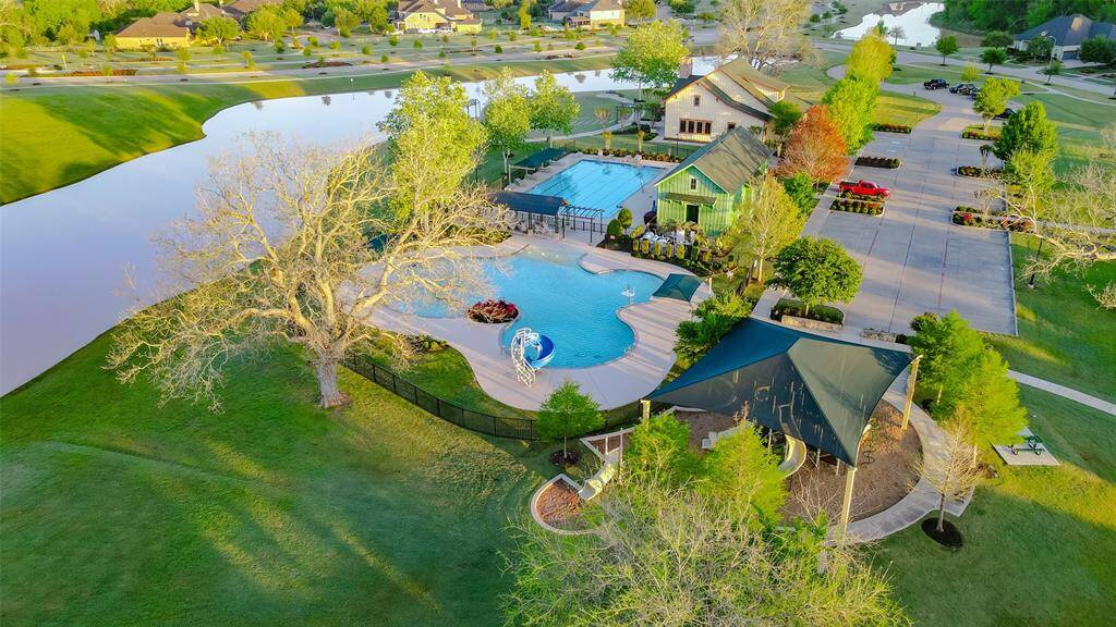 An aerial view of the Lodge and Sports Club showcases Huggins Lake in the backdrop, providing a tranquil setting for this community center. Here, you can find something for everyone.