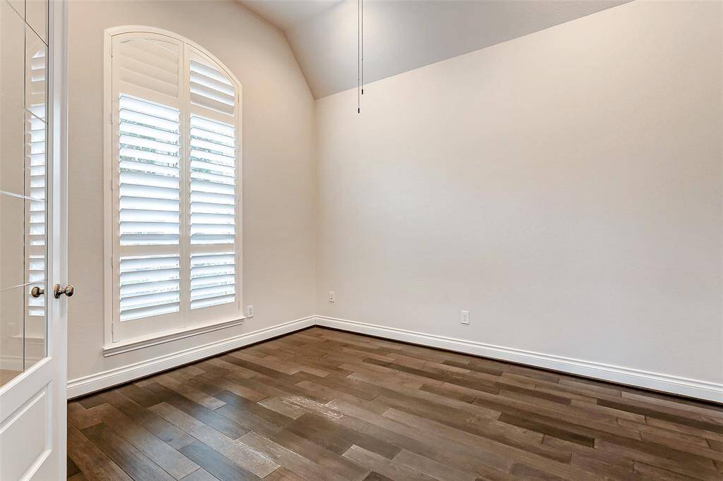 Located at the entrance of the home, behind elegant glass French doors, is a spacious and private home office, thoughtfully designed as a dedicated space for work or study. With an abundance of natural light pouring in, this tranquil retreat offers a quiet environment for focused productivity.