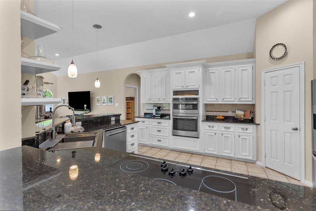 A chef’s dream—this open-concept kitchen boasts granite countertops, modern appliances, a breakfast bar, and plenty of cabinet space. It’s as functional as it is beautiful.