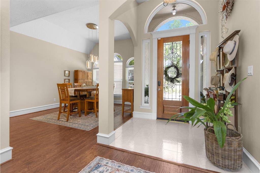 Step inside to rich wood laminate flooring and a warm, welcoming entry that sets the tone for the home's inviting atmosphere.