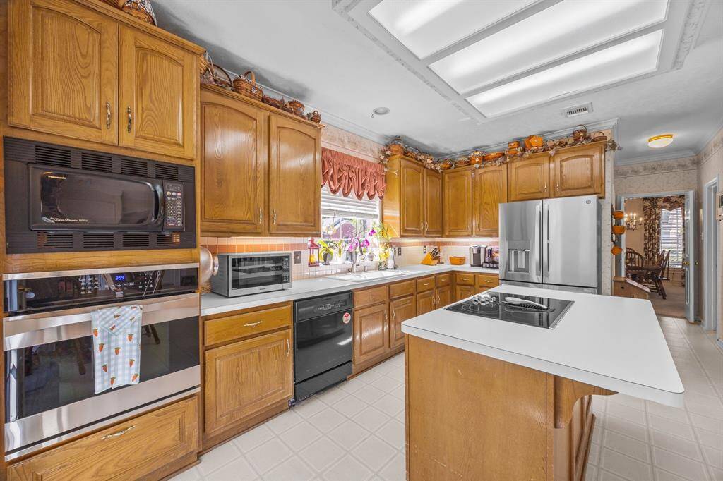 Spacious kitchen island with electric cooktop and extra seating.